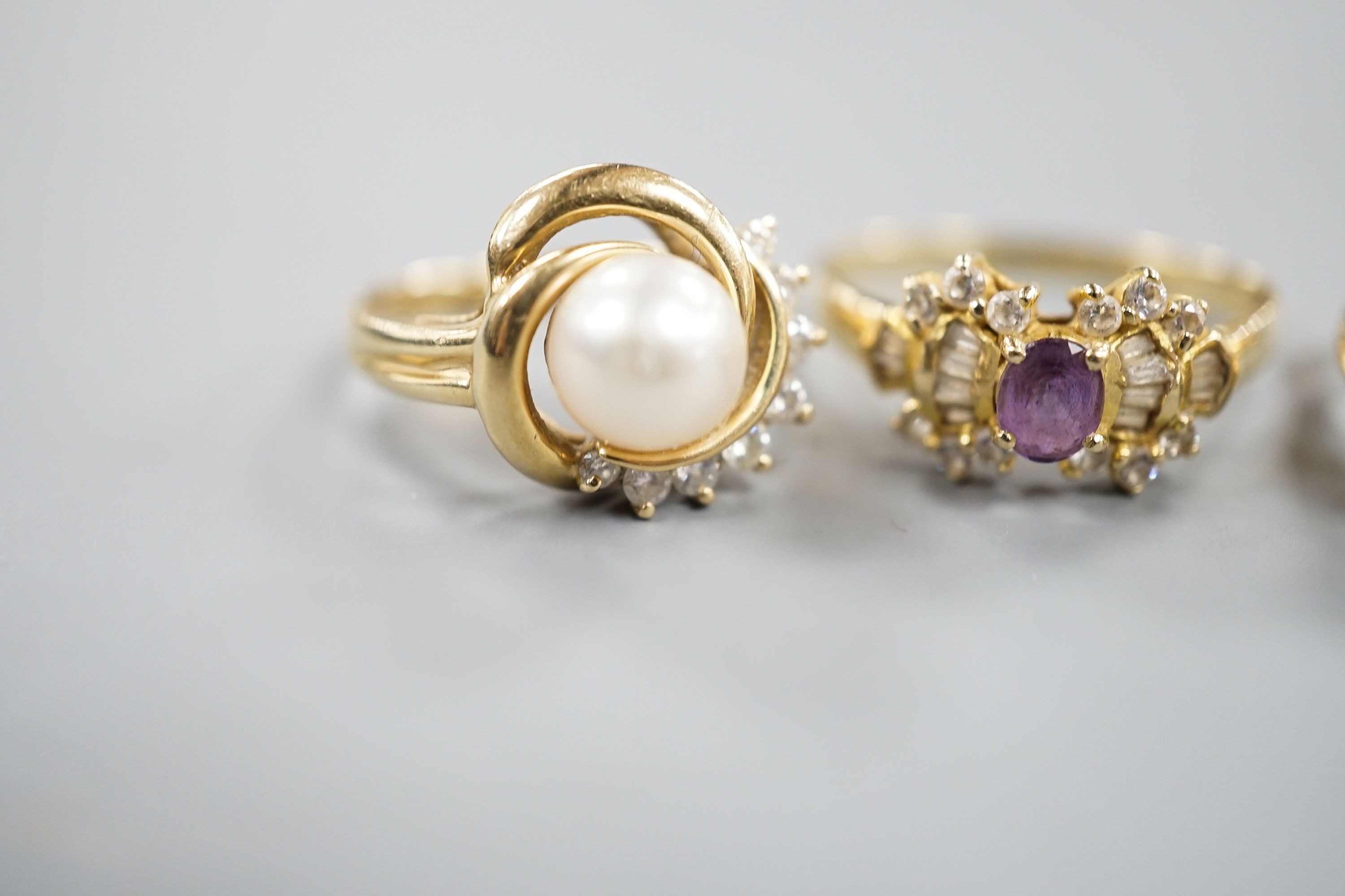 Three assorted modern 14k yellow metal and gem set dress rings, including cultured pearl and diamond, gross weight 10 grams.